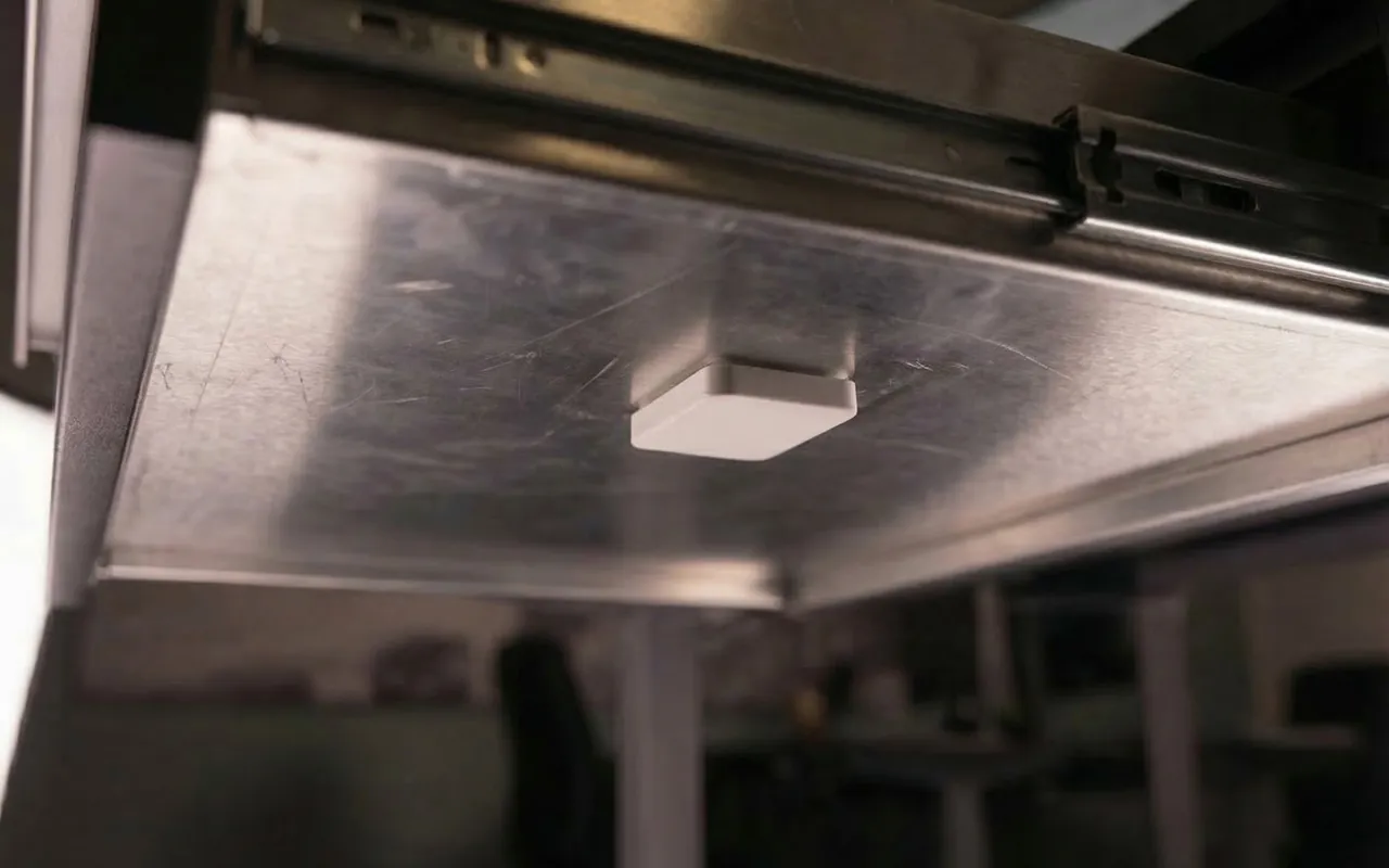 RoomAlyzer range extender under a desk, signal boost for wireless desk sensors