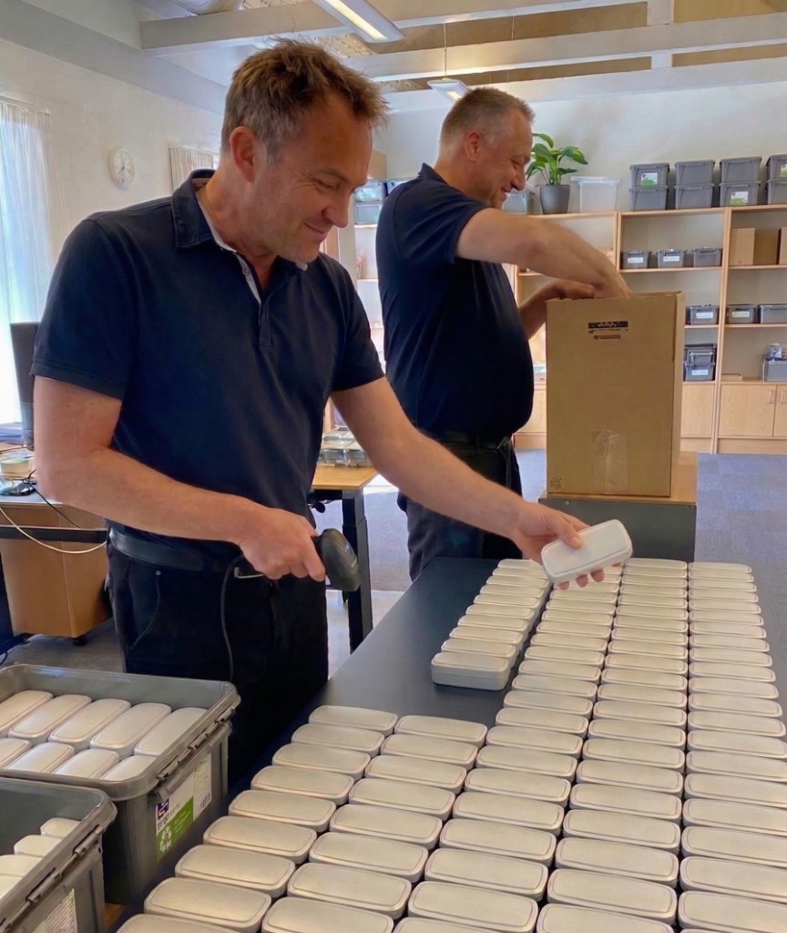IoT Fabrikken team members preparing and quality-checking sensors at the assembly bench